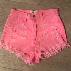 Bright pink distressed jean shorts